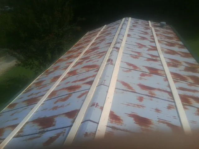 Rusted metal roof panels with new wood purlins before replacement — Storm Damage Roof Repair in Mira Loma by Roofing Brothers